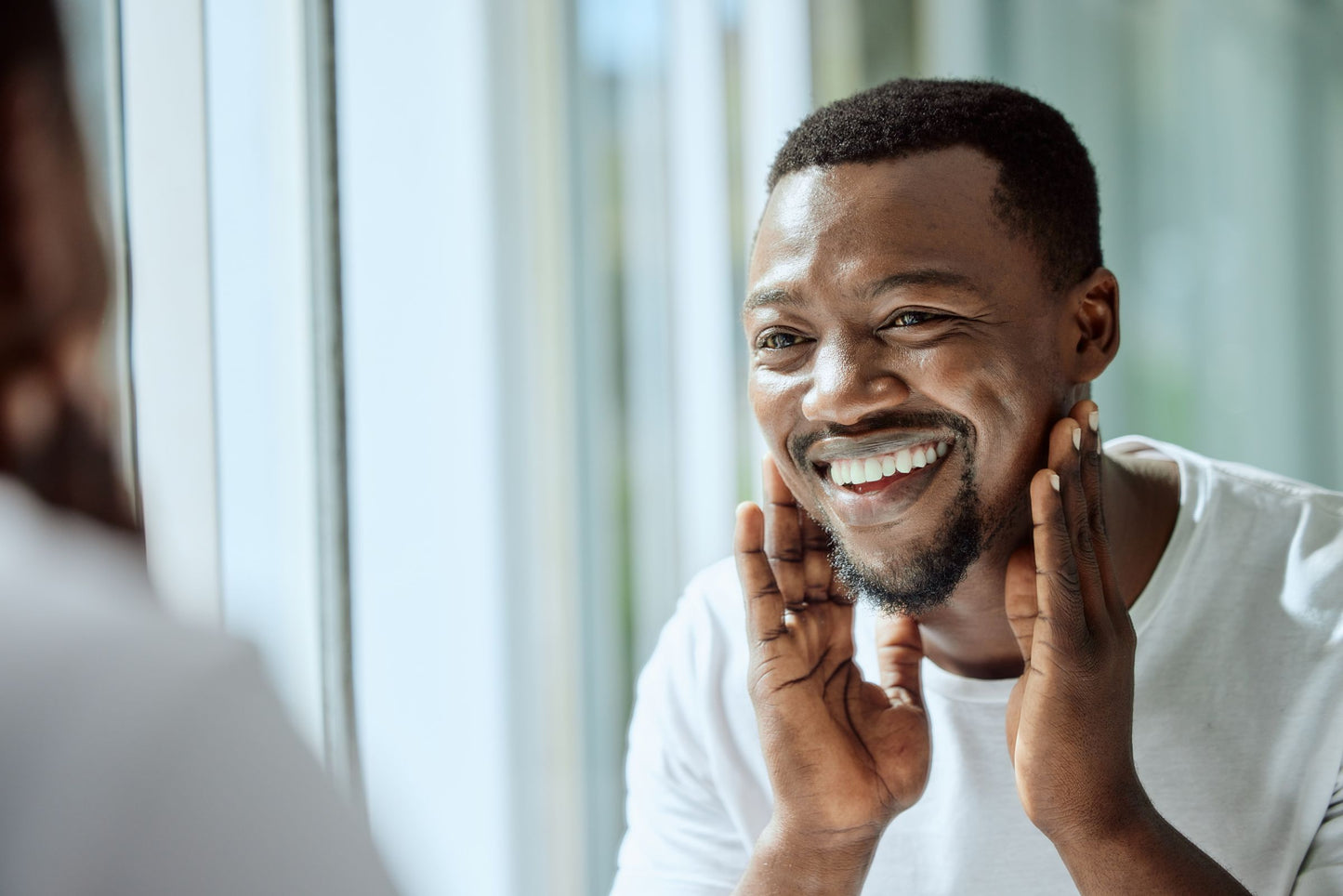 Man applying moisturizer to his face